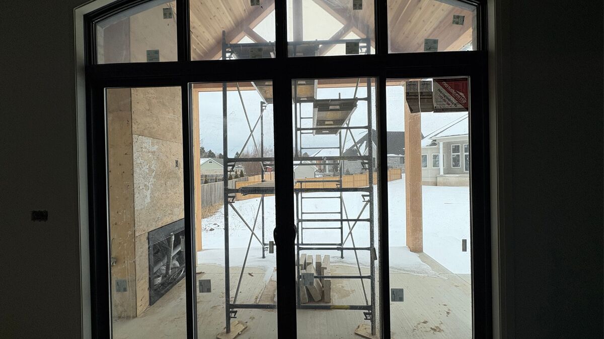 Patio doors lead out to the covered patio with outdoor fireplace thumbnail